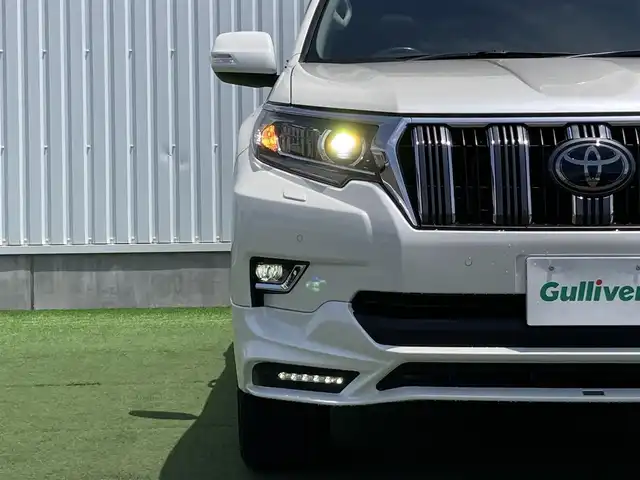 トヨタ ランドクルーザー プラド TX Lパッケージ 香川県 2019(令1)年 8万km ホワイトパールクリスタルシャイン 登録時走行距離：79972km/ディーラー純正9型ナビ/　CD DVD BT フルセグTV/バックカメラ/サンルーフ/TRDエアロ（フロント・リアアンダー）/オプション19インチアルミ/ブラックレザーシート/シートヒーター/エアシート/パワーシート/プリクラッシュセーフティシステム/レーンキープアシスト/レーダークルーズコントロール/ダウンヒルアシストコントロール/クリアランスソナー/ビルトインETC/ドライブレコーダー/MTモード付AT/横滑り防止装置/4WD/ディーゼルターボ/LEDヘッドライト/オートライト/フォグランプ/木目革巻きコンビステアリング/ステアリングスイッチ/プッシュスタート/スマートキー/スペアキー
