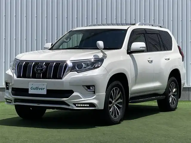 トヨタ ランドクルーザー プラド TX Lパッケージ 香川県 2019(令1)年 8万km ホワイトパールクリスタルシャイン 登録時走行距離：79972km/ディーラー純正9型ナビ/　CD DVD BT フルセグTV/バックカメラ/サンルーフ/TRDエアロ（フロント・リアアンダー）/オプション19インチアルミ/ブラックレザーシート/シートヒーター/エアシート/パワーシート/プリクラッシュセーフティシステム/レーンキープアシスト/レーダークルーズコントロール/ダウンヒルアシストコントロール/クリアランスソナー/ビルトインETC/ドライブレコーダー/MTモード付AT/横滑り防止装置/4WD/ディーゼルターボ/LEDヘッドライト/オートライト/フォグランプ/木目革巻きコンビステアリング/ステアリングスイッチ/プッシュスタート/スマートキー/スペアキー