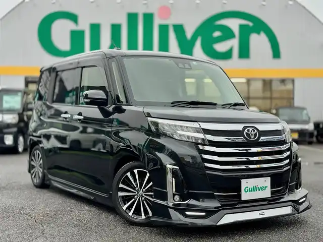 トヨタ ルーミー カスタムG－T 滋賀県 2022(令4)年 2.4万km ブラックマイカメタリック ワンオーナー/純正9インチフルセグナビ/　フルセグ Bluetooth CD DVD SD AM FM/パノラミックビューモニター/モデリスタエアロ /スマートアシスト/衝突回避支援ブレーキ/衝突警報機能/車線逸脱警報機能/路側逸脱警報/ふらつき警報/ブレーキ制御付誤発進抑制機能/先行車発進お知らせ機能/アダプティブドライビングビーム/サイドビューランプ/コーナーセンサー/標識認識機能/アダプティブクルーズコントロール/両側パワースライドドア/ビルトインETC/ローダウン（RSRダウンサス）純正サス積み込み/シートヒーター/純正15インチアルミ/純正ドアバイザー/純正フロアマット/スマートキー×2/