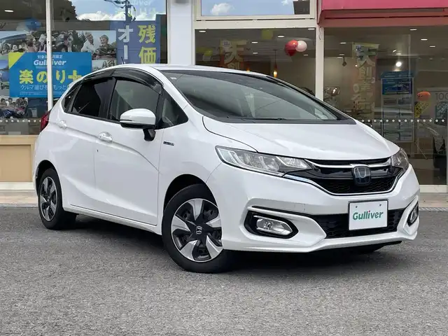 ホンダ フィット ハイブリット Fコンフォートエディション 長崎県 2019(令1)年 10.3万km プラチナホワイトパール 登録時102565km/純正ナビ/・TV/・Bluetooth/・DVD/ビルトインETC/バックカメラ/シートヒーター/レーダークルーズコントロール/ドライブレコーダー/電動格納ミラー/ドアバイザー