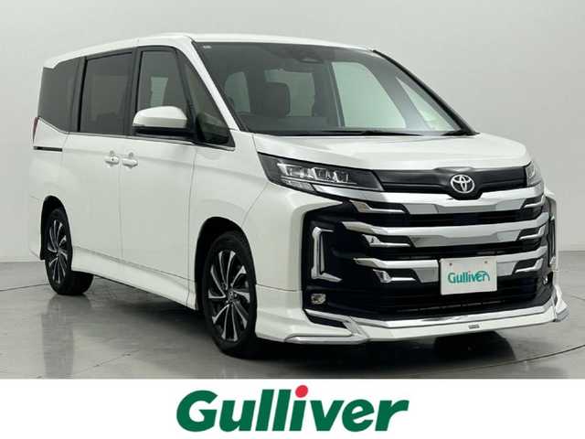 トヨタ ノア S－Z 熊本県 2022(令4)年 0.9万km ホワイトパールクリスタルシャイン 禁煙車　/モデリスタエアロ（Ｆ）/純正１０．５インチディスプレイオーディオ（ApplCarPlay・AndroidAuto・フルセグ・BT・HDMI・USB）　/純正13.2インチフリップダウンモニター　/レーダークルーズコントロール/バックカメラ　/ＥＴＣ２．０　/両側パワースライドドア　/前後クリアランスソナー　/前席シートヒーター/衝突軽減ブレーキ/駐車時支援パーキングサポートシステム/レーンキープアシスト/横滑り防止/前後クリアランスソナー/パーキングアシスト/ハーフレザーシート/社外フロアマット/純正17インチAW/オートライト/オートマチックハイビーム/フォグライト/スマートキー/プッシュスタート/スペアキー1本/保証書/取扱説明書