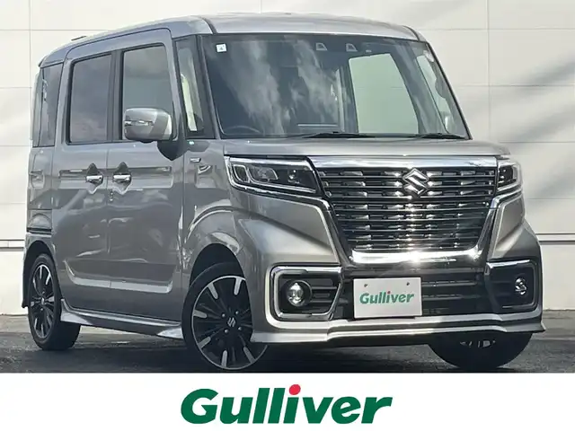 スズキ スペーシア カスタム HYBRID XS 佐賀県 2021(令3)年 6.4万km スチールシルバーM デュアルセンサーブレーキサポート/リアセンサー/レーダークルーズコントロール/純正8型SDナビ/・バックカメラ/・フルセグTV/BT/CD/DVD/前後ドライブレコーダー/両側パワースライドドア/純正15インチAW/LEDヘッドライト/オートライト/フォグランプ/ハーフレザーシート（合皮）/D席シートヒーター/ETC/革巻きステアリング/ヘッドアップディスプレイ/リアサーキュレーター/リアサンシェード/リアシートテーブル/プッシュスタート/スペアキー×1