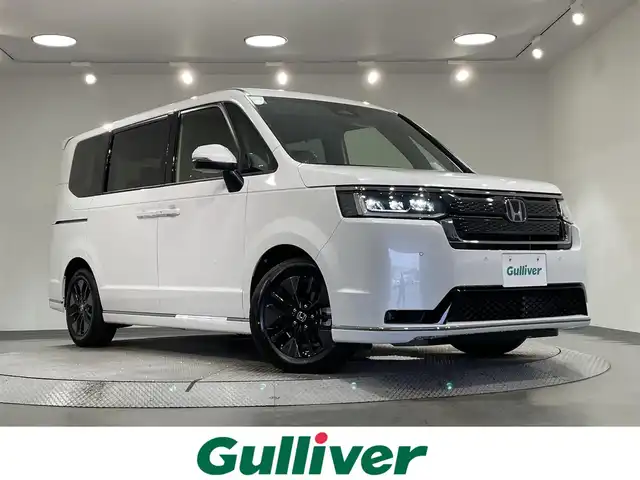 ホンダ ステップワゴン スパーダ eHEV 愛知県 2025(令7)年 0.1万km未満 プラチナホワイトパール 登録済未使用車/11.4インチナビHonda CONNECTナビ /(LXM-247VFLi)/ホンダセンシング/衝突軽減ブレーキ/両側パワースライドドア/レーダークルーズコントロール/レーンキープアシスト/コーナーセンサー/ブラインドスポットモニター/踏み間違い防止システム/シートヒーター/パワーテールゲート　/ＬＥＤヘッドライト/2列目オットマン/リアシェード/全列USBチャージャー