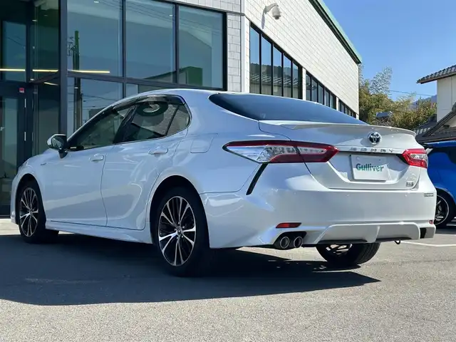 トヨタ カムリ WSレザーパッケージ 愛媛県 2019(令1)年 6.5万km プラチナホワイトパールマイカ 純正ナビ（Bluetooth/SD/フルセグテレビ）/ビルトインETC/バックカメラ/USB入力端子/追従型クルーズコントロール/リアクロストラフィックブレーキ/ブラインドスポットモニター/前後コーナーセンサー/前席パワーシート/前席シートヒーター/レーンキープアシスト/横滑り防止装置/衝突被害軽減システム/カーテンエアバック/純正18インチAW/LEDヘッドライト/フォグランプ/スペアキー