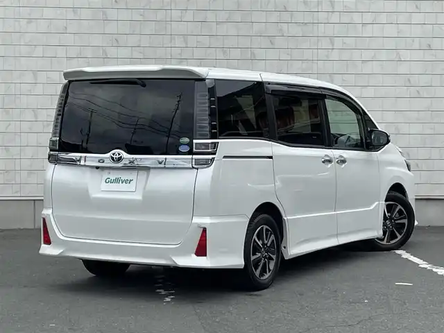 トヨタ ヴォクシー ZS 煌 愛知県 2019(平31)年 6.8万km ホワイトパールクリスタルシャイン ・純正SDメモリーナビ/・バックカメラ/・フルセグTV/・CD/DVD再生/・ETC（新セキュリティ対応）/・ミュージックサーバー（SD録音）/・Bluetooth接続/・3列シート/・両側パワースライドドア/・純正フロアマット/・純正16インチアルミホイール/・LEDヘッドライト/・オートマチックハイビーム/・コーナーセンサー（後方）/・横滑り防止装置/・衝突軽減ブレーキ/・レーンキープアシスト/・ドライブレコーダー（前）/・充電用USBポート（2個）/・MTモード付きAT/・クルーズコントロール/・全席オートエアコン/・モデリスタ シグネチャーイルミブレード