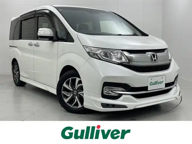 ホンダ ステップワゴン スパーダ ホンダセンシング 茨城県 2016(平28)年 7万km ホワイトオーキッドパール 純正9インチプレミアムインターナビ/ワンセグ/CD/DVD/Bluetooth/AM/FM/ホンダセンシング/・衝突軽減ブレーキ/・アダプティブ・クルーズ・コントロール/・車線維持支援システム/・路外逸脱抑制機能/・誤発進抑制機能/・先行車発進お知らせ機能/・標識認識機能/エアロ(フロント/サイド)/バックカメラ/フリップダウンモニター/LEDヘッドライト/オートライト/Clazziシートカバー