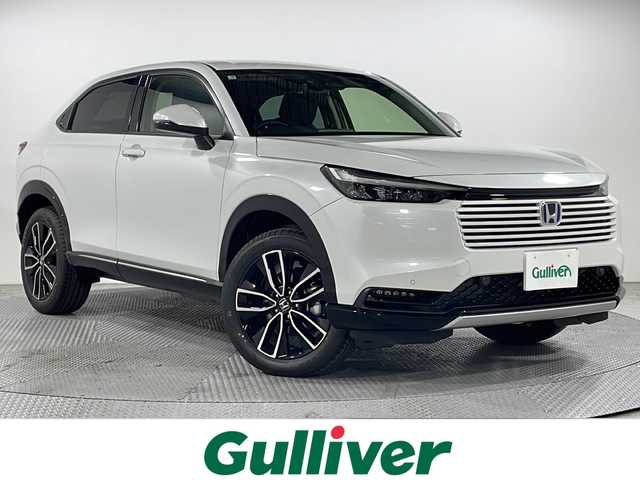 ホンダ ヴェゼル ハイブリッド e:HEV Z 広島県 2025(令7)年 0.1千km プラチナホワイトパール 登録済未使用車（5km）/9型Honda CONNECTディスプレイ/パワーテールゲート/ハーフレザーシート/シートヒーター/ステアリングヒーター/ホンダセンシング/・衝突軽減ブレーキ/・誤発進抑制機能/・レーンキープアシスト/・パーキングセンサー/・アダプティブクルーズコントロール/・アダプティブドライビングビーム/・ブラインドスポットインフォメーション/バックカメラ/減速セレクター/ヒルディセントコントロール/電動パーキングブレーキ/オートブレーキホールド/LEDヘッドランプ/オートライト/ETC2.0/ワイヤレス充電/USB入力端子