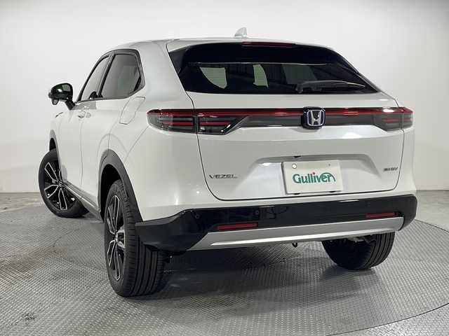 ホンダ ヴェゼル ハイブリッド e:HEV Z 広島県 2025(令7)年 0.1千km プラチナホワイトパール 登録済未使用車（5km）/9型Honda CONNECTディスプレイ/パワーテールゲート/ハーフレザーシート/シートヒーター/ステアリングヒーター/ホンダセンシング/・衝突軽減ブレーキ/・誤発進抑制機能/・レーンキープアシスト/・パーキングセンサー/・アダプティブクルーズコントロール/・アダプティブドライビングビーム/・ブラインドスポットインフォメーション/バックカメラ/減速セレクター/ヒルディセントコントロール/電動パーキングブレーキ/オートブレーキホールド/LEDヘッドランプ/オートライト/ETC2.0/ワイヤレス充電/USB入力端子