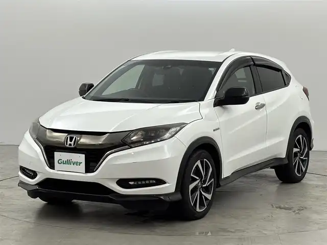 ホンダ ヴェゼル ハイブリッド RS ホンダセンシング 福岡県 2016(平28)年 6.3万km ホワイトオーキッドパール 純正ナビ（フルセグＴＶ）　/バックカメラ　/ホンダセンシング　/ＲＦＰ　/車両接近通報装置　/フロントガラス熱線　/エコモード　/横滑り防止　/ＥＴＣ　/ドラレコ　/純正１８インチアルミホイール　/純正フロアマット　/ＬＥＤ