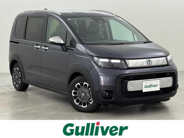 ホンダ フリード ハイブリット e:HEV クロスター 福岡県 2025(令7)年 0.1千km メテオロイドグレーメタリック 登録済未使用車　/純正ナビ／フルセグＴＶ　/バックカメラ　/レーダークルコン　/コーナーセンサー　/衝突軽減ブレーキ　/レーンキープ　/アクセル踏み間違い防止　/ＢＳＭ　/両側電動スライドドア　/シートヒーター　/ＬＥＤ