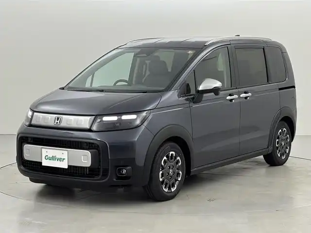 ホンダ フリード ハイブリット e:HEV クロスター 福岡県 2025(令7)年 0.1千km メテオロイドグレーメタリック 登録済未使用車　/純正ナビ／フルセグＴＶ　/バックカメラ　/レーダークルコン　/コーナーセンサー　/衝突軽減ブレーキ　/レーンキープ　/アクセル踏み間違い防止　/ＢＳＭ　/両側電動スライドドア　/シートヒーター　/ＬＥＤ