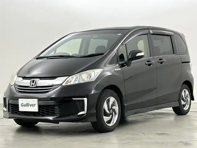 ホンダ フリード ハイブリット ジャストセレクション 福岡県 2014(平26)年 10.3万km プレミアムスパークルブラックパール フリップダウンモニター/純正ナビ/・CD/DVD/BT/フルセグ/バックカメラ/両側パワースライドドア/クルーズコントロール/ETC/ドライブレコーダー/キセノンライト/横滑り防止