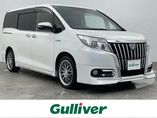 トヨタ エスクァイア ハイブリッド Gi 大分県 2014(平26)年 11.1万km ホワイトパールクリスタルシャイン ワンオーナー/ALPINEナビ/・AM/FM/CD/DVD/Bluetooth/・フルセグテレビ/フリップダウンモニター/両側パワースライド/バックカメラ/シートヒーター（D席+N席）/ワイヤレス充電器/ダブルオートエアコン/オートライト/スマートキー/スペアキー/プッシュスタートボタン/LEDヘッドライト/社外17インチアルミホイル/純正フロアマット/保証書/取扱説明書