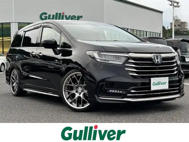 ホンダ オデッセイ ハイブリッド e:HEVアブソルート EX 島根県 2021(令3)年 1.8万km プレミアムスパークルブラックパール 登録時走行距離17207km/Honda純正ナビ（Gathers）/Bluetooth・Radio・CD・DVD/ETC2.0/デジタルインナーミラー（ALPINE）/フリップダウンモニター/Honda　SENSING/マルチビューカメラシステム/Hondaスマートパーキングアシスト/ブラインドスポットインフォメーション/LEDアクティブコーナリングライト/2列目プレミアムクレードルシート/運転席・助手席シートヒーター/運転席８ウェイパワーシート/助手席４ウェイパワーシート/運転席大型アームレスト/プライムスムース×ファブリックコンビシート/AC 100V 1500W/センターコンソールボックス/列目LEDアンビエントライトランプ/シーケンシャルターンシグナルランプ/ハンズフリーアクセスパワーテールゲート/両側パワースライドドア/20インチ社外AW