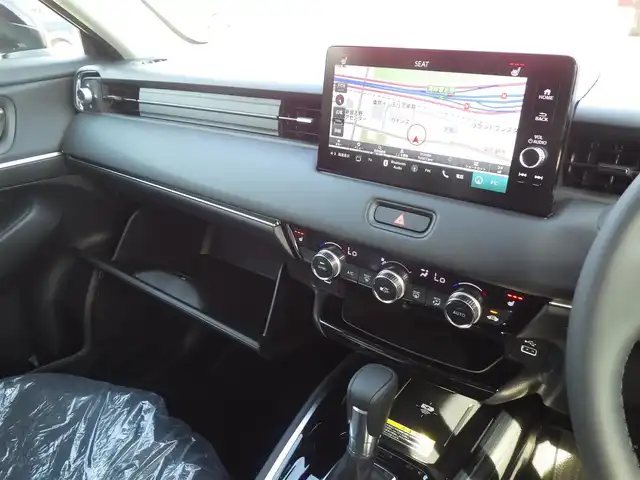 ホンダ ヴェゼル ハイブリッド e:HEV Z 千葉県 2025(令7)年 0.1千km クリスタルブラックパール e:HEV Z　4VC4AZ　Honda CONNECTディスプレー+ETC2.0車載器+ワイヤレス充電器(231000)/ホンダセンシング/・衝突軽減ブレーキ（CMBS）/・車線維持支援システム（LKAS）/・アダプティブクルーズコントロール（ACC）/・後方誤発進抑制機能/・誤発進抑制機能/パワーバックドア/ハーフレザーシート/前席シートヒーター/純正コネクトナビ/地デジTV/【Bluetooth接続】/【Apple CarPlay　Android Auto対応】/バックカメラ/ワイヤレス充電/革巻きステアリング/ステアリングヒーター/ステアリングスイッチ/パドルシフト/ETC（2.0）/LEDヘッドライト/フォグライト/ウインカーミラー/コーナーセンサー/純正18インチアルミホイル/サイド/カーテンエアバッグ/Honda スマートキー