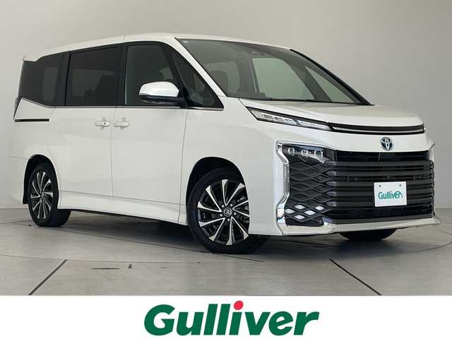 トヨタ ヴォクシー ハイブリッド S－Z 愛知県 2023(令5)年 3.5万km ホワイトパールクリスタルシャイン トヨタチームメイト/アドバンストパーク/アドバンストドライブ/純正ディズプレイオーディオナビ/フリップダウンモニター/両側パワースライドドア/レーダークルーズコントロール/シートヒーター/バックカメラ/ヘッドアップディスプレイ/コーナーセンサー/純正アルミホイール/ETC2.0/ブラインドスポットモニター/LEDヘッドライト/インテリジェントミラー/リアオートエアコン/オートマチックハイビーム/ドライブレコーダー/衝突軽減システム/Bluetooth/ステアリングスイッチ/スマートキー/プッシュスタート