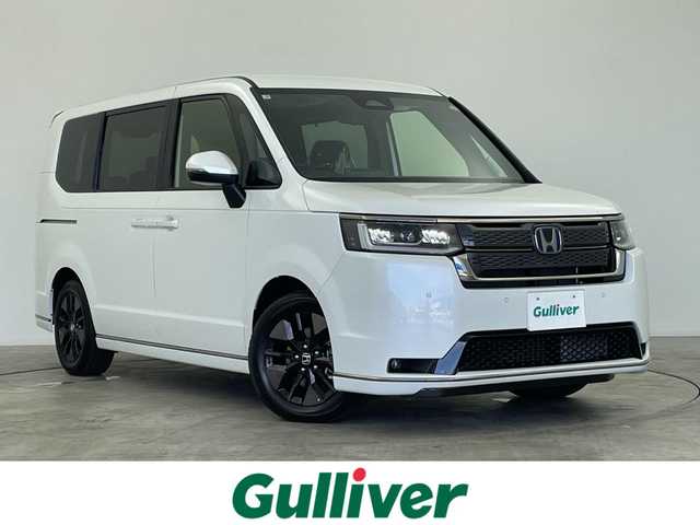 ホンダ ステップワゴン スパーダ eHEV 群馬県 2025(令7)年 0.1千km プラチナホワイトパール 登録済み未使用車　純正11.4インチナビ　バックカメラ　衝突軽減　両側パワースライドドア　BSM　アダプティブクルーズコントロール　レーンアシスト　パワーリアゲート　オットマン　シートヒーター　禁煙車