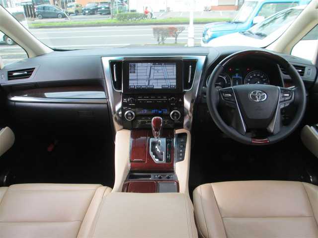 トヨタ ヴェルファイア ハイブリット V Lエディション 道央・札幌 2015(平27)年 3.9万km ホワイトパールクリスタルシャイン ワンオーナー/モデリスタエアロ/メーカーナビ、フルセグTV/JBLサウンドシステム/パノラミックビューモニター/リアエンターテイメントシステム/プリクラッシュセーフティ/ベージュレザーシート/前席パワーシート/シートヒーター/セカンドセミパワーシート/パワーバックドア/LEDヘッドライト&LEDフォグ/純正17インチアルミホイール/ウッドコンビハンドル/ステアリングヒーター/前後ドライブレコーダー/ビルトインETC/新車整備手帳/取扱説明書/スペアキー