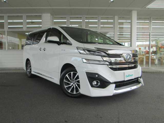 トヨタ ヴェルファイア ハイブリット V Lエディション 道央・札幌 2015(平27)年 3.9万km ホワイトパールクリスタルシャイン ワンオーナー/モデリスタエアロ/メーカーナビ、フルセグTV/JBLサウンドシステム/パノラミックビューモニター/リアエンターテイメントシステム/プリクラッシュセーフティ/ベージュレザーシート/前席パワーシート/シートヒーター/セカンドセミパワーシート/パワーバックドア/LEDヘッドライト&LEDフォグ/純正17インチアルミホイール/ウッドコンビハンドル/ステアリングヒーター/前後ドライブレコーダー/ビルトインETC/新車整備手帳/取扱説明書/スペアキー