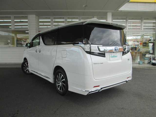 トヨタ ヴェルファイア ハイブリット V Lエディション 道央・札幌 2015(平27)年 3.9万km ホワイトパールクリスタルシャイン ワンオーナー/モデリスタエアロ/メーカーナビ、フルセグTV/JBLサウンドシステム/パノラミックビューモニター/リアエンターテイメントシステム/プリクラッシュセーフティ/ベージュレザーシート/前席パワーシート/シートヒーター/セカンドセミパワーシート/パワーバックドア/LEDヘッドライト&LEDフォグ/純正17インチアルミホイール/ウッドコンビハンドル/ステアリングヒーター/前後ドライブレコーダー/ビルトインETC/新車整備手帳/取扱説明書/スペアキー