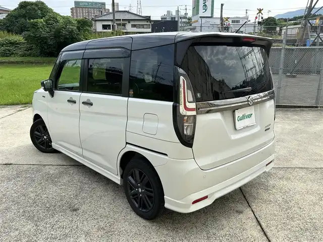スズキ ソリオ HV SZ 長崎県 2023(令5)年 2.7万km ピュアホワイトパール/ガンメタリック2トーン 純正9インチナビ/（Bluetooth/フルセグ）/全方位カメラ/衝突軽減システム/レーンアシスト/レーダークルーズ/ETC/両側パワースライドドア/ヘッドアップディスプレイ/パドルシフト/前後ドライブレコーダー/バックソナー/純正15インチAW