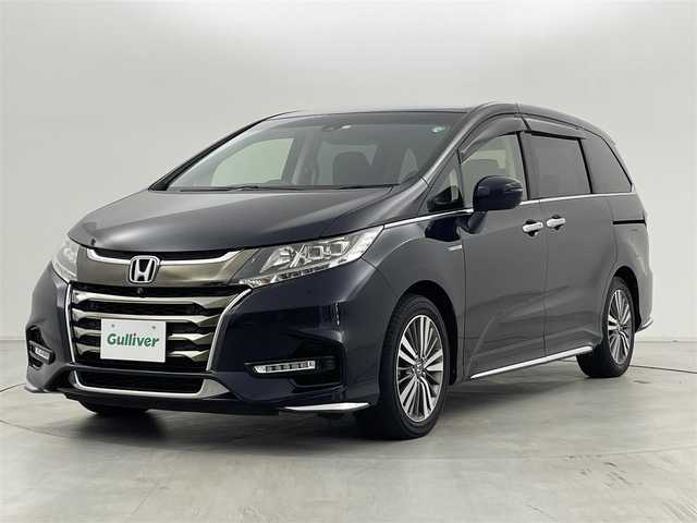 ホンダ オデッセイ ハイブリッド アブソルート・EXホンダセンジング 群馬県 2020(令2)年 2.4万km プレミアムヴィーナスブラックP 純正9インチHondaインターナビ/（フルセグＴＶ/BT/CD/DVD/AM/FM）/ビルトインETC2.0/===============/マルチビューカメラシステム/スマートパーキングアシスト/両側パワースライドドア/前席シートヒーター/前席パワーシート/後退出庫サポート/ブラインドスポットモニター/ホンダセンシング/・衝突軽減ブレーキ〈CMBS〉/・誤発進抑制機能/・歩行者事故低減ステアリング/・路外逸脱抑制機能/・渋滞追従機能付ACC〈アダプティブ・クルーズ・コントロール〉/・LKAS〈車線維持支援システム〉/・先行車発進お知らせ機能/・標識認識機能/AC100V電源/デジタルミラー型ドライブレコーダー/大型アームレスト・センターコンソール