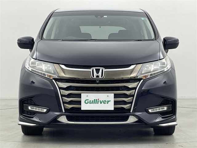 ホンダ オデッセイ ハイブリッド アブソルート・EXホンダセンジング 群馬県 2020(令2)年 2.4万km プレミアムヴィーナスブラックP 純正9インチHondaインターナビ/（フルセグＴＶ/BT/CD/DVD/AM/FM）/ビルトインETC2.0/===============/マルチビューカメラシステム/スマートパーキングアシスト/両側パワースライドドア/前席シートヒーター/前席パワーシート/後退出庫サポート/ブラインドスポットモニター/ホンダセンシング/・衝突軽減ブレーキ〈CMBS〉/・誤発進抑制機能/・歩行者事故低減ステアリング/・路外逸脱抑制機能/・渋滞追従機能付ACC〈アダプティブ・クルーズ・コントロール〉/・LKAS〈車線維持支援システム〉/・先行車発進お知らせ機能/・標識認識機能/AC100V電源/デジタルミラー型ドライブレコーダー/大型アームレスト・センターコンソール