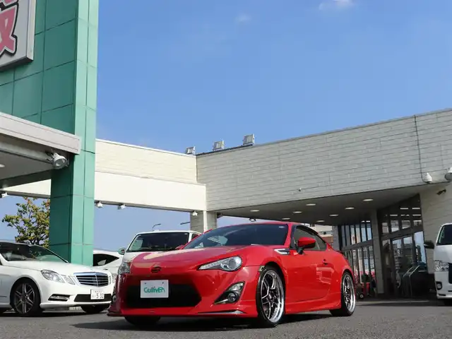 トヨタ ８６ GT リミテッド 神奈川県 2012(平24)年 5.7万km ライトニングレッド モデリスタエアロ（F・S・R）/TOM’S4本出しマフラー/：TOM’S4スモークテールレンズ/車高調/社外メモリナビ/Bluetoothオーディオ/バックカメラ/プッシュスタート/ドライブレコーダー（前後）/社外シルバーメッキ19インチアルミホイール/：235/35R19/ハーフレザーシート/：シートヒーター/フロアマット