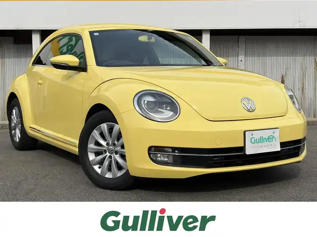 フォルクスワーゲン ザ・ビートル デザイン 三重県 2013(平25)年 5.6万km サンフラワー 登録時走行距離５５３７７km/カロツェリアナビ　/　・フルセグTV/　・DVD/CD再生/　・SD/バックカメラ/キーレス/スモークフィルム/HIDヘッドライト/フォグライト/リアフォグライト /革巻きステアリング/電動格納ミラー/フロアマット/横滑り防止機能