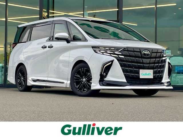 トヨタ アルファードハイブリット Z 東京都 2024(令6)年 1.4万km プラチナホワイトパールマイカ モデリスタフルエアロ〔REGAL DIGNITY STYLE〕/モデリスタシグネチャーイルミブレード/左右独立ムーンルーフ/ユニバーサルステップ/純正14型ディスプレイオーディオ/　・ナビ/フルセグTV/純正フリップダウンモニター/パノラミックビューモニター/アドバンストパーク/トヨタセーフティセンス/レーダークルーズコントロール/オートマチックハイビーム/クリアランスソナー/BSM/両側パワースライドドア/ワイヤレス充電/AC100V/ビルトインETC2.0/エグゼクティブパワーシート/シートヒーター/ベンチレーション/ステアリングヒーター/純正18インチAW〔ブラック塗装〕/3眼LEDヘッドライト/スマートキー/純正フロアマット/プッシュスタート/スマートキー