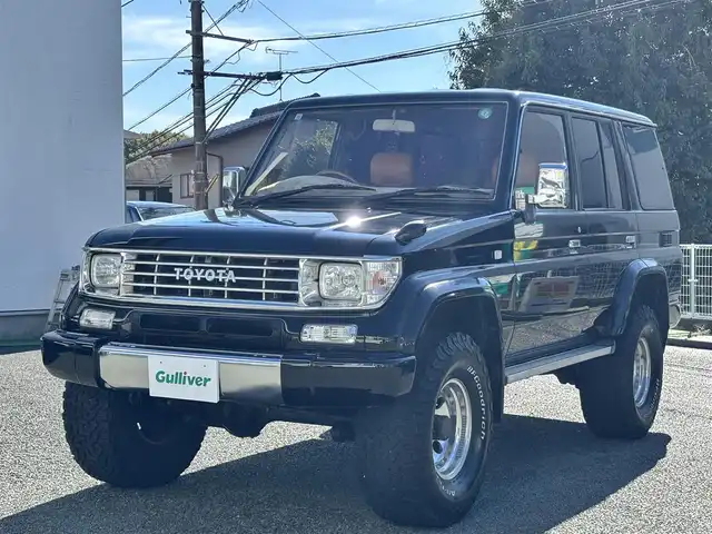 トヨタ ランドクルーザー プラド SX ワイド 熊本県 1995(平7)年 14.4万km 黒 2インチアップ車/NARDIステアリング/社外ナビ/【フルセグTV/CD/DVD/BT/SD】/バックカメラ/革調シートカバー/純正15インチAW/ETC/純正フロアマット