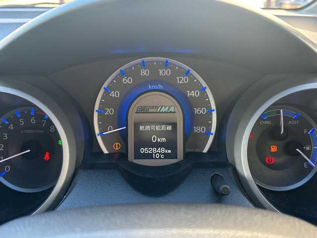 ホンダ フィット ハイブリット 10thアニバーサリー 広島県 2012(平24)年 5.3万km プレミアムホワイトパール 禁煙/純正ナビ（VXM-128VS）/・ワンセグ/CD/DVD/SD/USB/クルーズコントロール/電動格納ウィンカーミラー/HIDパッケージ/・ディスチャージヘッドライト〈HID〉/・シルバー塗装インナードアハンドル/・ブラック塗装フロントピラーガーニッシュ/ドアバイザー/純正フロアマット/スマートキー/社外アルミホイール