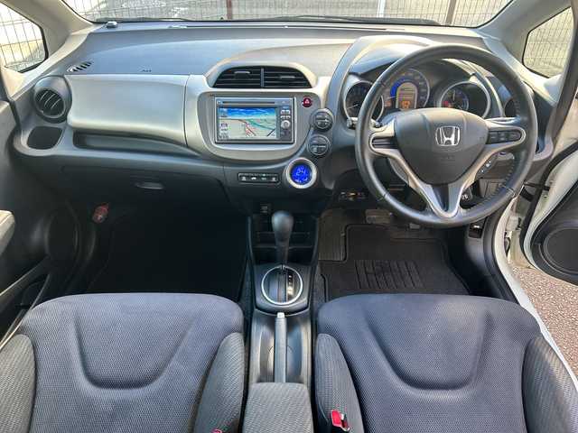 ホンダ フィット ハイブリット 10thアニバーサリー 広島県 2012(平24)年 5.3万km プレミアムホワイトパール 禁煙/純正ナビ（VXM-128VS）/・ワンセグ/CD/DVD/SD/USB/クルーズコントロール/電動格納ウィンカーミラー/HIDパッケージ/・ディスチャージヘッドライト〈HID〉/・シルバー塗装インナードアハンドル/・ブラック塗装フロントピラーガーニッシュ/ドアバイザー/純正フロアマット/スマートキー/社外アルミホイール