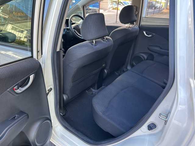 ホンダ フィット ハイブリット 10thアニバーサリー 広島県 2012(平24)年 5.3万km プレミアムホワイトパール 禁煙/純正ナビ（VXM-128VS）/・ワンセグ/CD/DVD/SD/USB/クルーズコントロール/電動格納ウィンカーミラー/HIDパッケージ/・ディスチャージヘッドライト〈HID〉/・シルバー塗装インナードアハンドル/・ブラック塗装フロントピラーガーニッシュ/ドアバイザー/純正フロアマット/スマートキー/社外アルミホイール