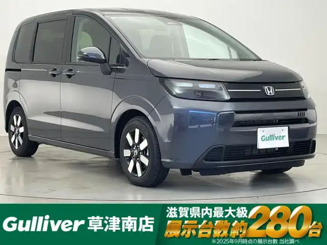 ホンダ フリード ハイブリット e:HEV AIR EX 滋賀県 2025(令7)年 0.1千km メテオロイドグレーメタリック 登録済未使用車/純正9型メモリーナビ/・Bluetooth/USB/フルセグ/・AndroidoAuto/AppleCarPlay/ホンダセンシング/追従クルーズコントロール/ハーフレザーシート/シートヒーター/BSM/バックカメラ/電子パーキング/LEDライト/純正１５AW