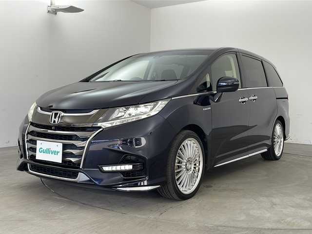 ホンダ オデッセイ ハイブリッド アブソルート・EXホンダセンジング 兵庫県 2018(平30)年 3.1万km プレミアムヴィーナスブラックP ・純正ナビ/CD/DVD/Bluetooth/TV/・マルチビューカメラシステム/・ビルトインETC2.0/・純正フリップダウンモニター/・Honda　SENSING/衝突軽減ブレーキ/誤発進抑制機能/歩行者事故低減ステアリング/路外逸脱抑制機能/アダプティブ・クルーズ・コントロール/車線維持支援システム/先行車発進お知らせ機能/標識認識機能/・ブラインドスポットモニター/・ハーフレザー/・前席シートヒーター/・ステアリングスイッチ/・社外１９インチアルミホイール/・ＬＥＤヘッドライト/・フォグランプ/・オートライト/・プッシュスタート/・スマートキー/・電子パーキング/・オートホールド/・ミラーヒーター/・フロアマット/・2列目サンシェード