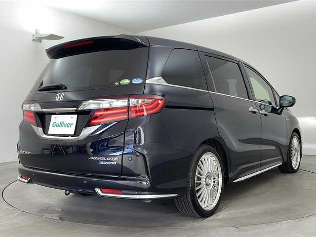 ホンダ オデッセイ ハイブリッド アブソルート・EXホンダセンジング 兵庫県 2018(平30)年 3.1万km プレミアムヴィーナスブラックP ・純正ナビ/CD/DVD/Bluetooth/TV/・マルチビューカメラシステム/・ビルトインETC2.0/・純正フリップダウンモニター/・Honda　SENSING/衝突軽減ブレーキ/誤発進抑制機能/歩行者事故低減ステアリング/路外逸脱抑制機能/アダプティブ・クルーズ・コントロール/車線維持支援システム/先行車発進お知らせ機能/標識認識機能/・ブラインドスポットモニター/・ハーフレザー/・前席シートヒーター/・ステアリングスイッチ/・社外１９インチアルミホイール/・ＬＥＤヘッドライト/・フォグランプ/・オートライト/・プッシュスタート/・スマートキー/・電子パーキング/・オートホールド/・ミラーヒーター/・フロアマット/・2列目サンシェード