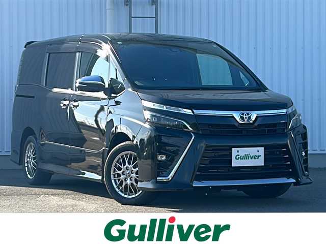 トヨタ ヴォクシー ハイブリッド ZS 煌Ⅱ 愛媛県 2020(令2)年 7.1万km ブラック 純正ナビ/Bluetooth/CD/DVD/USB/フルセグ/両側パワースライドドア/バックカメラ/ETC/クルーズコントロール/前席シートヒーター/純正フロアマット/純正16インチAW/アイドリングストップ/コーナーセンサー/オートライト/LEDヘッドライト/フォグランプ/保証書/取扱説明書