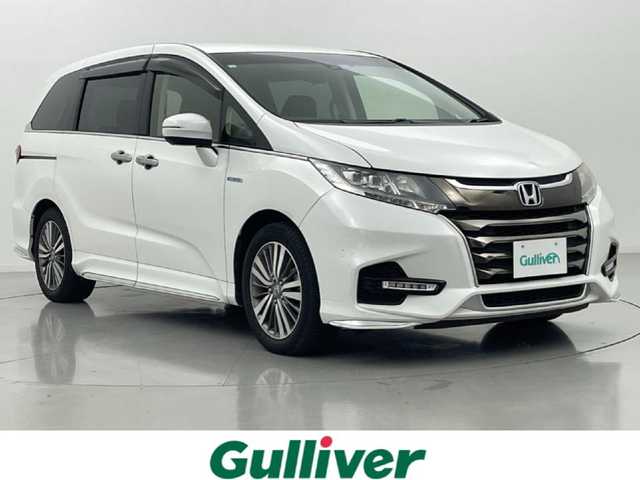ホンダ オデッセイ ハイブリッド アブソルート ホンダセンシング 熊本県 2018(平30)年 8.2万km プラチナホワイトパール 純正ナビ（ＣＤ・ＤＶＤ・フルセグ・ＢＴ・ＳＤ・ｉｐｏｄ・HDMI）/バックカメラ　/純正前方ドライブレコーダー　/ビルトインＥＴＣ2.0　/両側パワースライドドア　/ホンダセンシング/・衝突軽減ブレーキ/・レーダークルーズコントロール/・先行車発進お知らせ機能/・路外逸脱制御機能/・レーンキープアシスト/・標識認識機能/横滑り防止/運転席パワーシート/ハーフレザーシート/純正フロアマット/純正１７インチAW/オートライト/LEDヘッドライト/フォグライト/スマートキー/プッシュスタート/保証書/取扱説明書