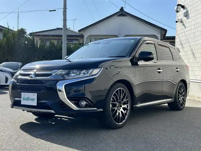 三菱 アウトランダー ＰＨＥＶ G プレミアムパッケージ 山形県 2016(平28)年 9.4万km アメジストブラック 4WD/純正SDナビ/フルセグTV/FM/AM/クルーズコントロール/全周囲カメラ/社外サス（純正有り）/ステアリングヒーター/黒革シート&シートヒーター/パワーバックドア/パドルソフト/衝突軽減ブレーキ/ドライブレコーダー/パドルシフト/バックカメラ/ETC/純正アルミ付き冬タイヤ積載/充電ケーブル