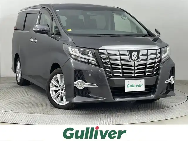 トヨタ アルファード S 道央・札幌 2016(平28)年 7万km グレーメタリック ・４WD/・寒冷地仕様/・純正SDナビ/・CD/DVD/SD/BT/フルセグ/・バックカメラ/・純正12インチフリップダウンモニター/・ビルトインETC/・クリアランスソナー/・ECOモード/・横滑り防止/・アイドリングストップ/・両側パワースライドドア/・ステアリングスイッチ/・ウォークスルー/・オットマン/・LEDヘッドライト/・フォグランプ/・純正18インチAW/・純正フロアマット/・プッシュスタート/・スマートキー/・取扱説明書/・保証書