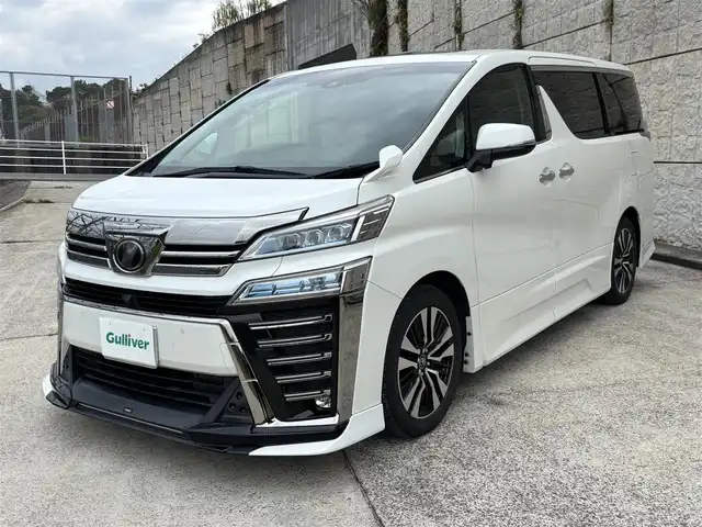 トヨタ ヴェルファイア ZG 長崎県 2019(平31)年 8.3万km ホワイトパールクリスタルシャイン ワンオーナー/TRDエアロ（F/S/R下）/サンルーフ/社外11インチナビ/（CD/DVD/BT/フルセグ）/フリップダウンモニター/衝突軽減システム/レーンアシスト/ブラインドスポットモニター/両側パワースライドドア/パワーバックドア/デジタルインナーミラー/パワーシート/シートヒーター/エアシート/ハンドルヒーター/純正18インチAW
