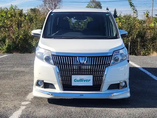 トヨタ エスクァイア ハイブリッド Gi 群馬県 2015(平27)年 7.1万km ホワイトパールクリスタルシャイン モデリスタエアロ(F/S/R)/純正9型ナビ/フルセグTV/純正11型後席ディスプレイ/両側パワースライドドア/バックモニター/ビルトインETC/ドライブレコーダー/クルーズコントロール/クリアランスソナー/LEDヘッドランプ/オートライト/デュアルオートエアコン/木目調/革巻きコンビステアリング/ステアリングスイッチ/合皮シート/モデリスタ17インチアルミホイール/スマートキー/プッシュエンジンスタート/禁煙車