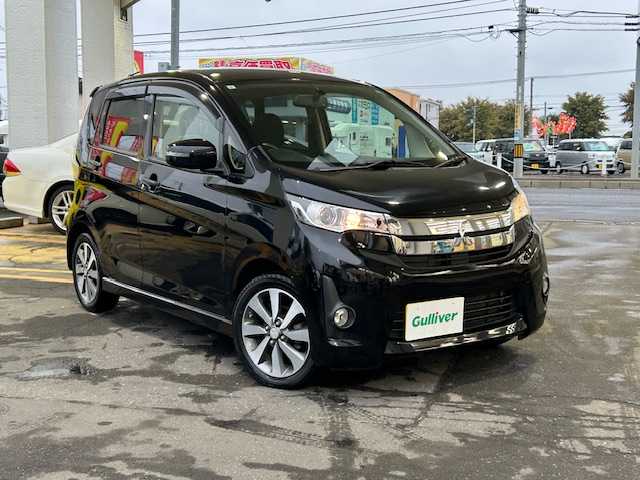 三菱 ｅＫカスタム T 道東・釧路十勝 2013(平25)年 5.7万km アメジストブラック 4WD/純正メモリーナビ/  (CD/フルセグTV)/バックカメラ/シートヒーター/HIDヘッドライト/フォグライト/ウィンカーミラー/電動格納ミラー/革巻きステアリング/純正フロアマット/純正ドアバイザー/スマートキー/エンジンプッシュスタート/純正15インチアルミホイール/冬タイヤ積み込み/  (155/65R14、7mm、2024年製、社外AW)