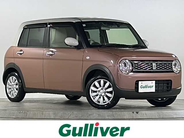 スズキ ラパン X 広島県 2024(令6)年 1.1万km テラコッタピンクメタリック/ソフトベージュ 2トーン 禁煙車/フルタイム４WD/デュアルカメラブレーキサポート/車線逸脱警報/オートハイビーム/純正８型ナビ（CN-FZ896）/・フルセグTV/・CD/Bluetooth/SD/REC/USB/全方位モニター/ステアリングスイッチ/革巻きステアリング/オートライト/D/Nシートヒーター/LEDヘッドライト/コーナーセンサー/電動格納ミラー/スマートキー/プッシュスタート/スペアキー/純正前後ドライブレコーダー/ETC/純正ドアバイザー/純正14インチアルミホイール