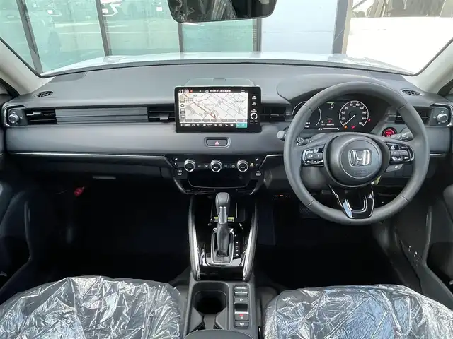 ホンダ ヴェゼル ハイブリッド e:HEV Z 香川県 2025(令7)年 0.1千km プラチナホワイトパール 登録済未使用車/純正９型ナビ/ワイヤレス充電器/バックカメラ/ビルトインＥＴＣ２．０/ホンダセンシング/レーダークルーズコントロール/ＢＳＭ/パドルシフト/ハンドルヒーター/シートヒーター/ハーフレザーシート/スペアキー/スマートキー