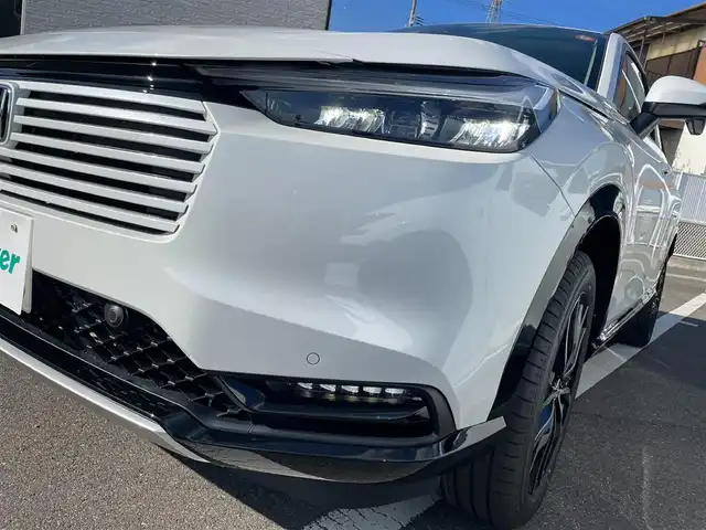 ホンダ ヴェゼル ハイブリッド e:HEV Z 香川県 2025(令7)年 0.1千km プラチナホワイトパール 登録済未使用車/純正９型ナビ/ワイヤレス充電器/バックカメラ/ビルトインＥＴＣ２．０/ホンダセンシング/レーダークルーズコントロール/ＢＳＭ/パドルシフト/ハンドルヒーター/シートヒーター/ハーフレザーシート/スペアキー/スマートキー