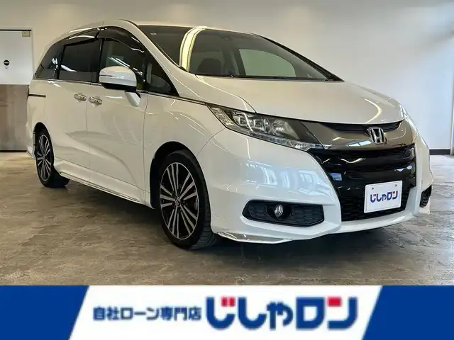 ホンダ オデッセイ アブソルート 20thアニバーサリー 静岡県 2015(平27)年 10.8万km ホワイトオーキッドパール (株)IDOMが運営する【じしゃロン浜松店】の自社ローン専用車両になりますこちらは現金またはオートローンご利用時の価格です。自社ローンご希望の方は別途その旨お申付け下さい/純正ナビ（VXM-155VFEi)/CD/DVD/AM/FM/Bluetooth/バックカメラ/両側パワースライドドア/LEDヘッドライト/LEDルームランプ/Honda　SENSING/●誤発進抑制機能/●先行車発進お知らせ機能/●標識認識機能/●LKAS〈車線維持支援システム〉/●路外逸脱抑制機能/●ACC〈アダプティブ・クルーズ・コントロール〉