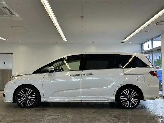 ホンダ オデッセイ アブソルート 20thアニバーサリー 静岡県 2015(平27)年 10.8万km ホワイトオーキッドパール (株)IDOMが運営する【じしゃロン浜松店】の自社ローン専用車両になりますこちらは現金またはオートローンご利用時の価格です。自社ローンご希望の方は別途その旨お申付け下さい/純正ナビ（VXM-155VFEi)/CD/DVD/AM/FM/Bluetooth/バックカメラ/両側パワースライドドア/LEDヘッドライト/LEDルームランプ/Honda　SENSING/●誤発進抑制機能/●先行車発進お知らせ機能/●標識認識機能/●LKAS〈車線維持支援システム〉/●路外逸脱抑制機能/●ACC〈アダプティブ・クルーズ・コントロール〉