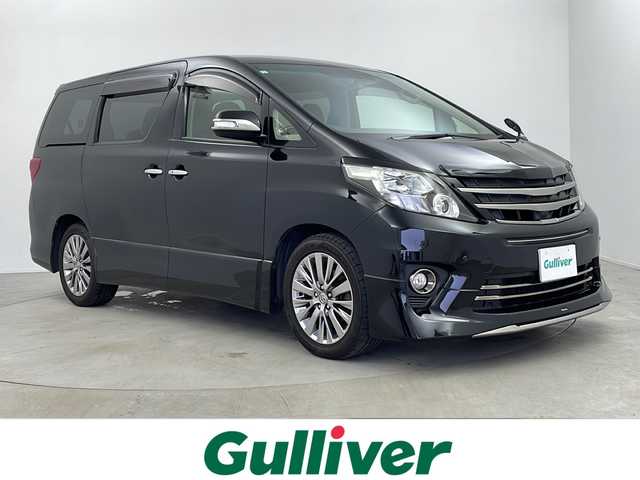 トヨタ アルファード 240S タイプゴールド 埼玉県 2013(平25)年 6.6万km ブラック 社外ナビ/(Bluetooth/SD/CD/DVD/フルセグTV)/フリップダウンモニターTMX-R3000/モデリスタフロントスポイラー/バックカメラ/両側パワースライドドア/クルーズコントロール/ETC/シートカバー/純正18インチアルミホイール/純正フロアマット/ドアバイザー/キセノンヘッドライト/フォグランプ/オートライト/スペアキー/プッシュスタート/スマートキー/横滑り防止装置/盗難防止装置/社外グリル